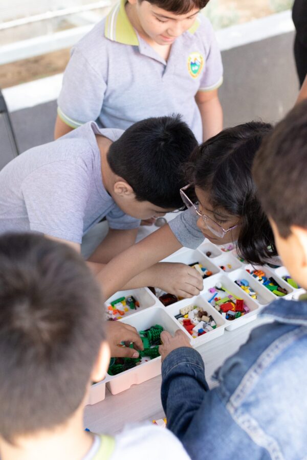 Participantes construyendo con piezas LEGO
